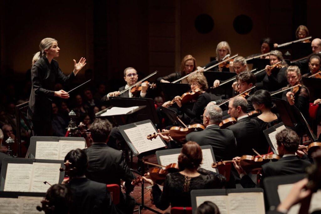 Karina Canellakis conducting the RCO with Axel Schacher, guest leader
