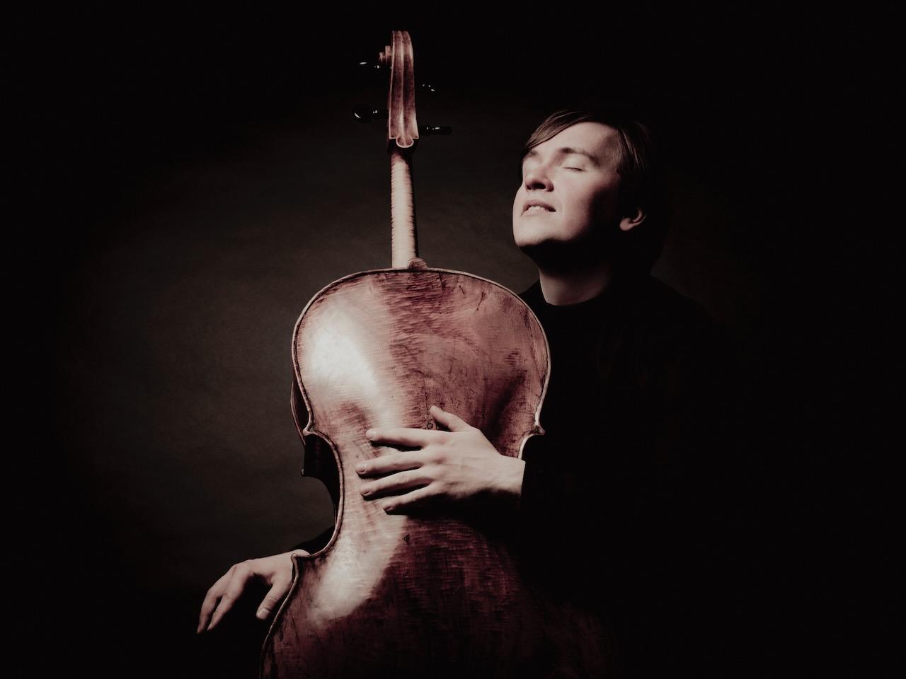 Ivan Karizna holding his cello