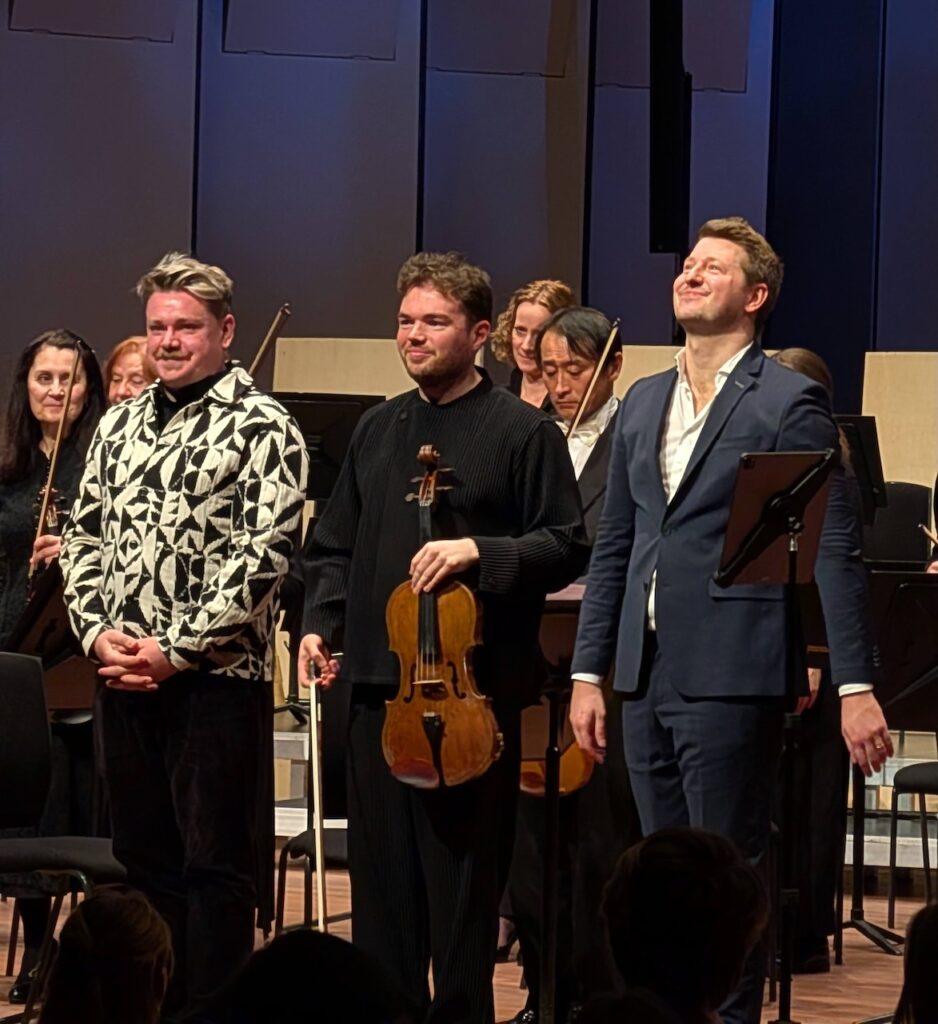 Three men taking a bow